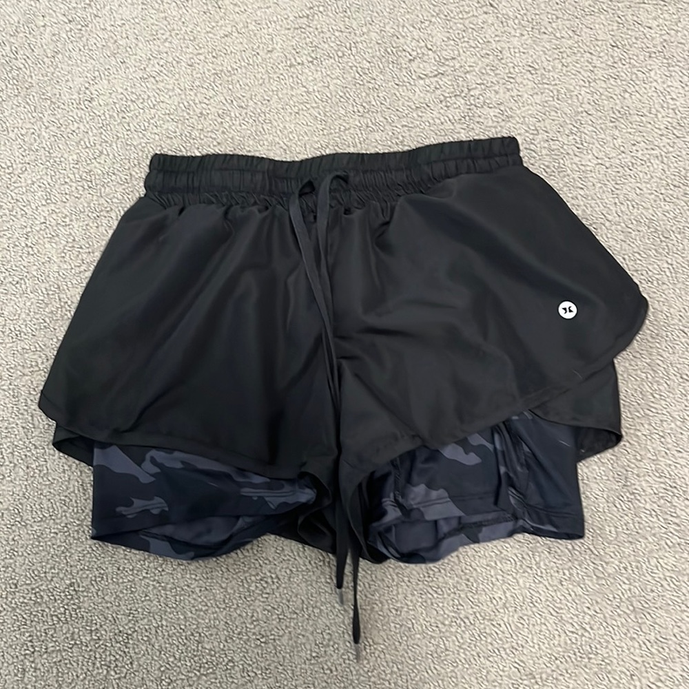 Black shorts with black camo tight shirts underneath.